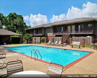 a large swimming pool in front of a building