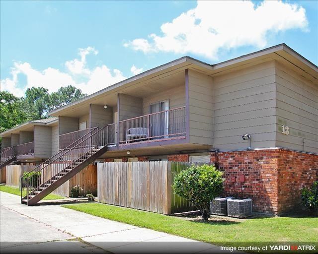 a house with a staircase and a yard