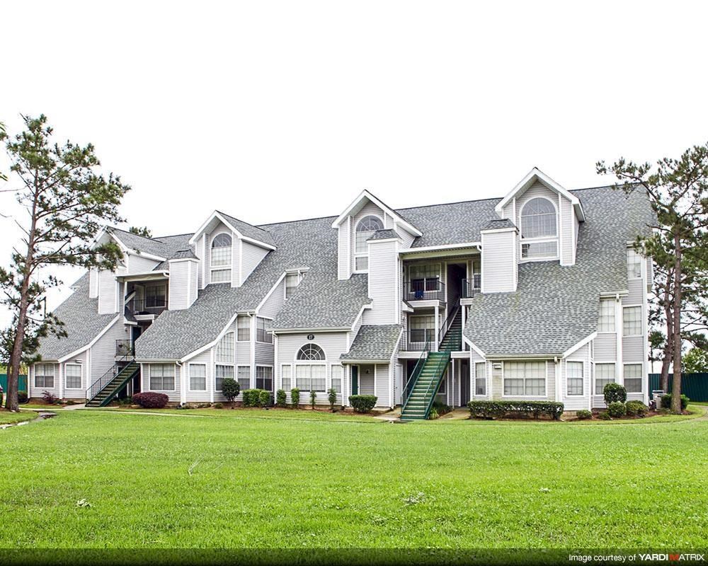 a large house with a green lawn in front of it