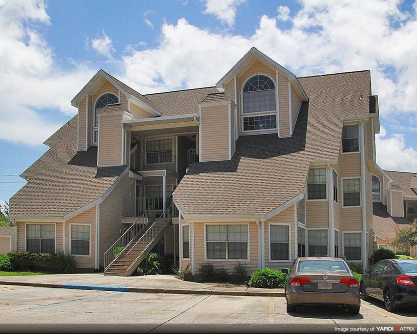 a large house with cars parked in front of it