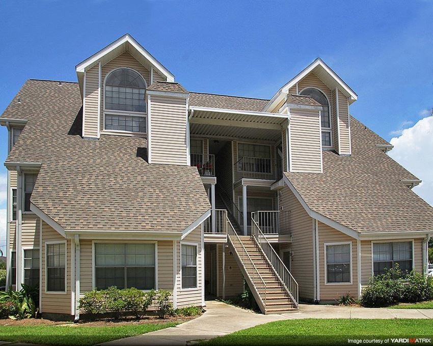 the front of a house with stairs and a roof