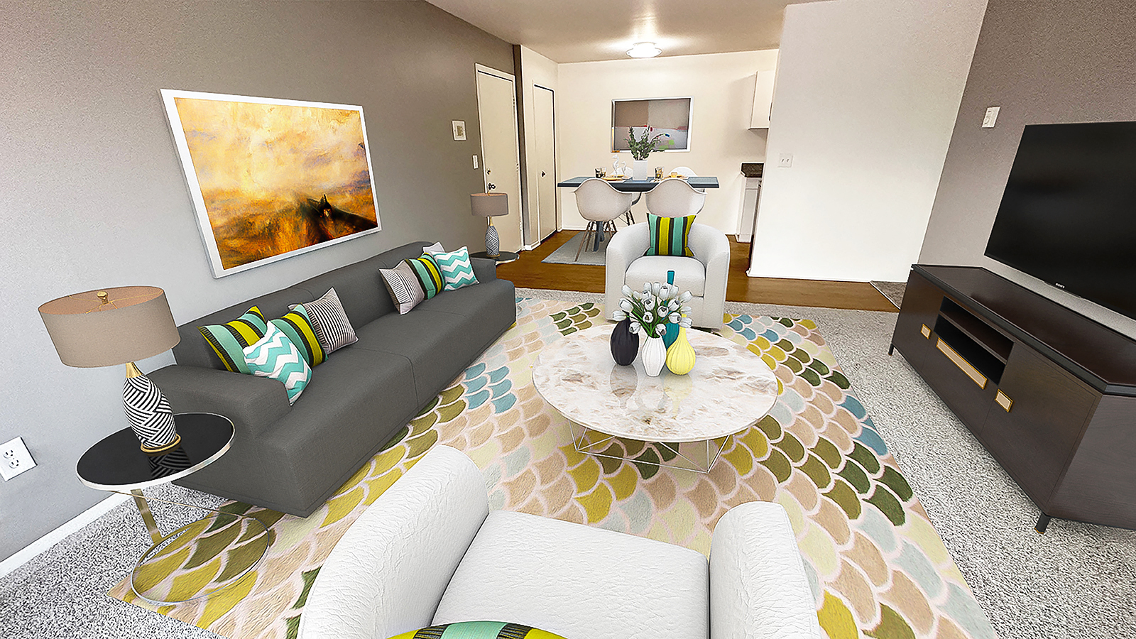 A living room with a grey couch and a coffee table.