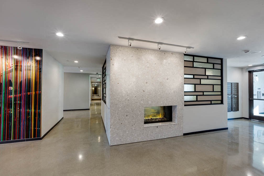 a large concrete fireplace in the center of a room