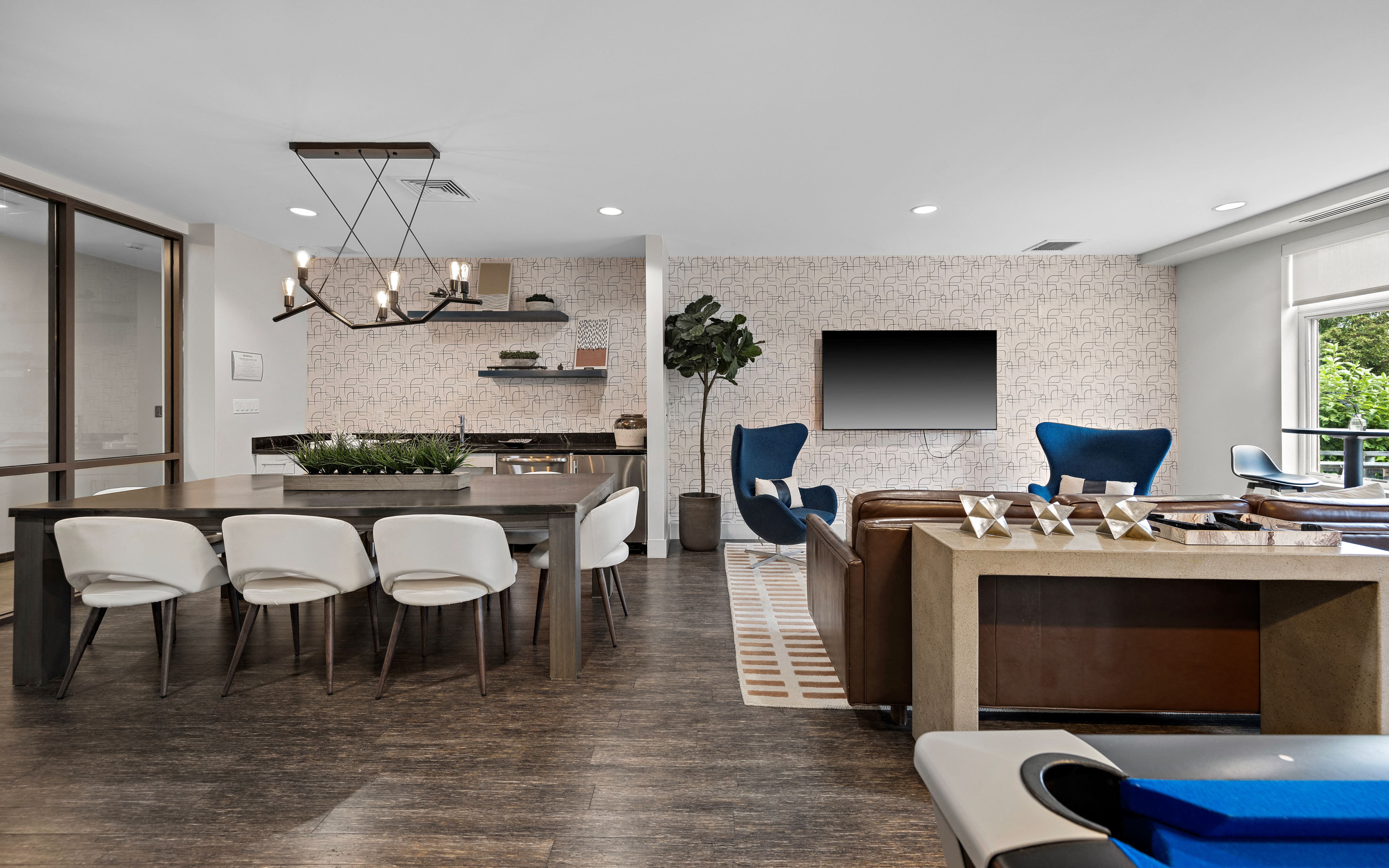 a clubhouse with a dining room and a bar and a television
