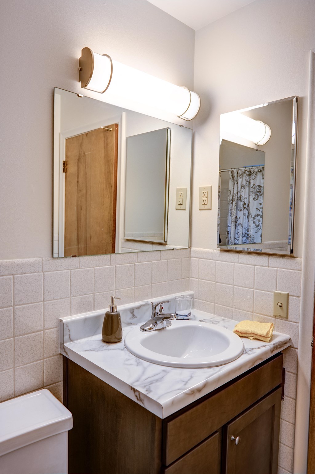 a bathroom with a sink and a mirror and a toilet