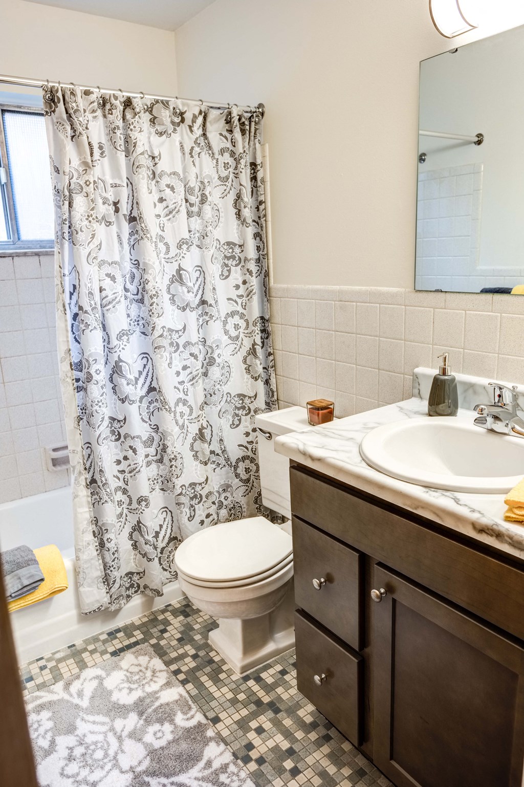 a bathroom with a shower curtain and a sink and a toilet