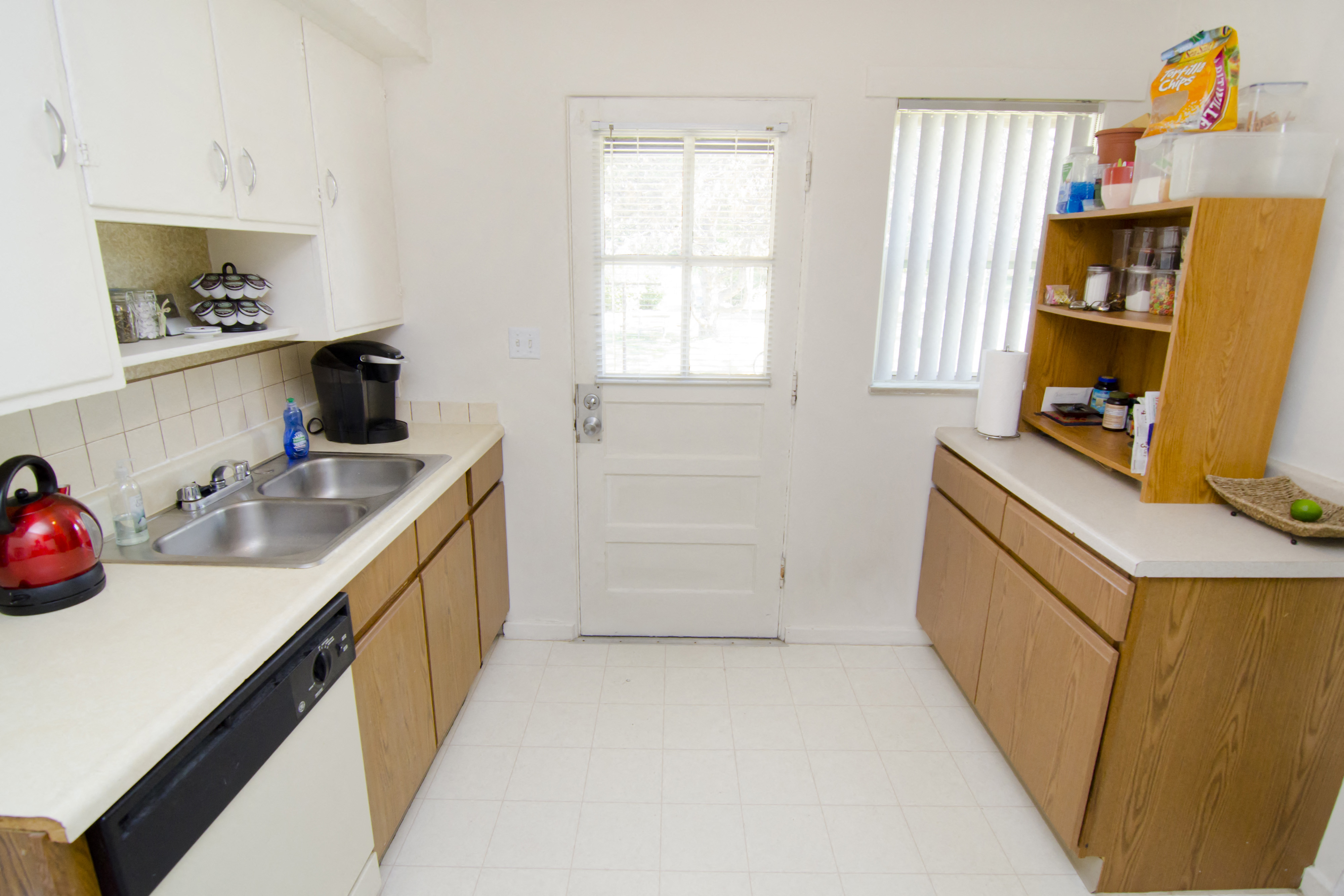 a kitchen with a sink and a door