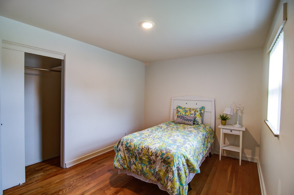 a bedroom with a bed and a white closet