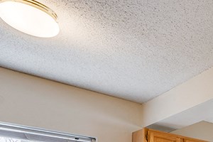 kitchen island overlooking empty, carpeted living room