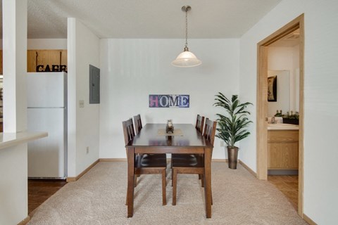 a dining room with a wooden table and chairs