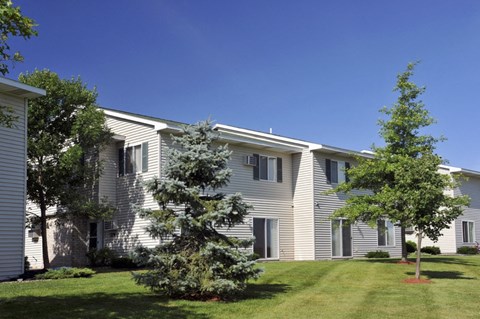 an apartment building with trees in front of it