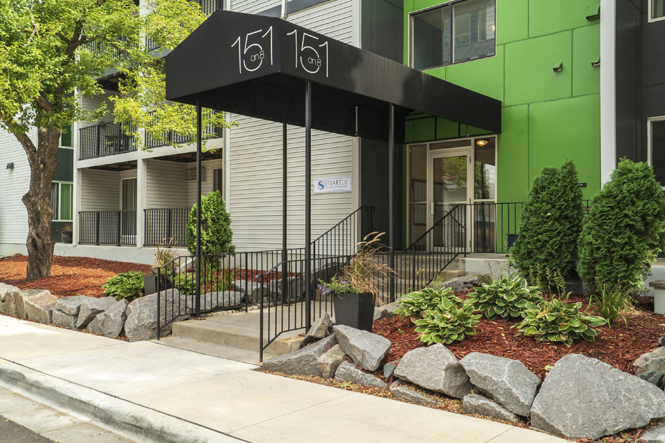 apartment entrance with a black awning that reads "151 on 8"