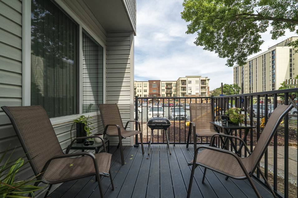 furnished patio with buildings behind it