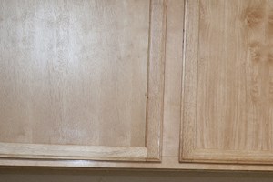 kitchen with wood cabinets, black dishwasher, white oven, and a sink - Photo Gallery