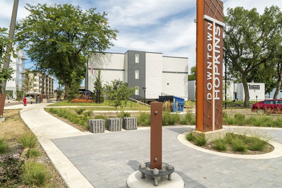 outdoor footpaths and a sign that reads "Downtown Hopkins"