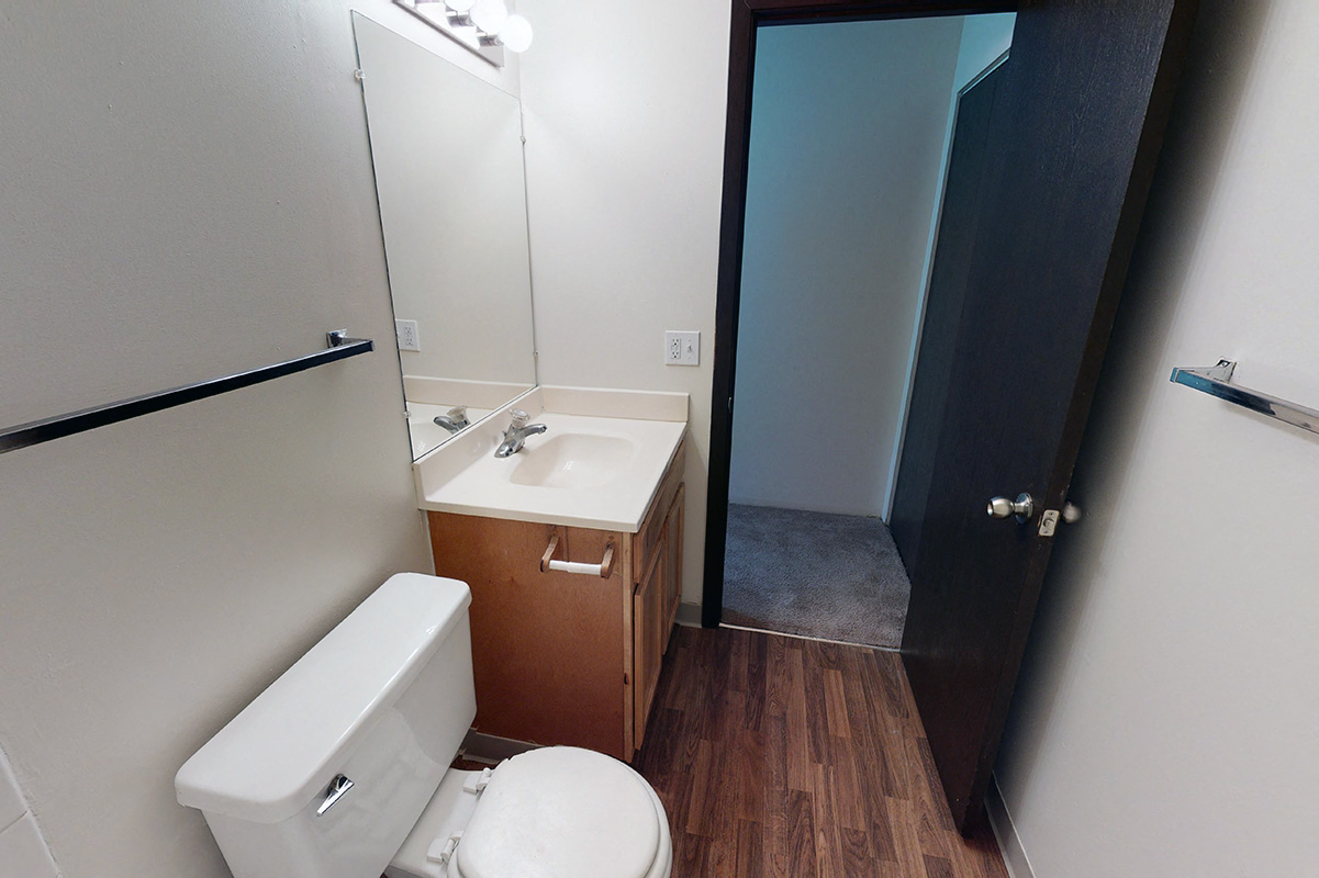 Bathroom with sink next to toilet on one side