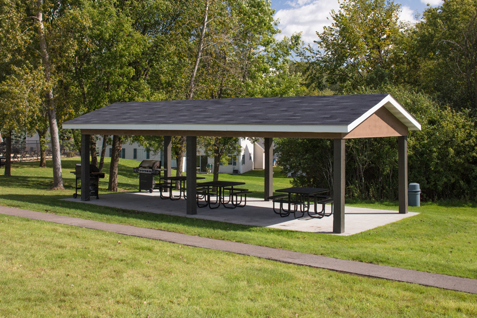 outdoor gazebo with benches underneath it