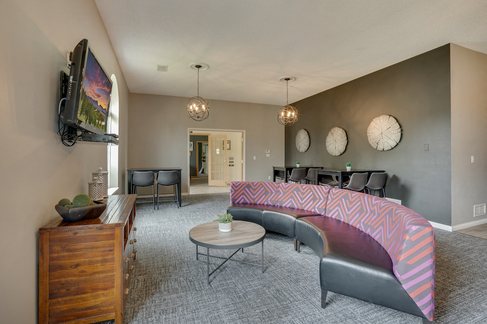 couch facing a television mounted on the wall