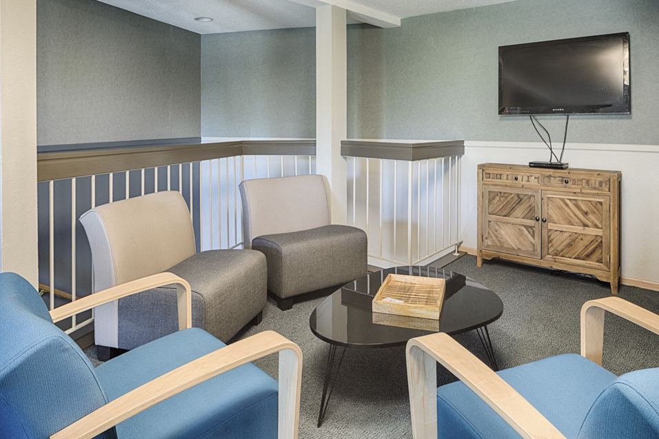 Community room with chairs facing a television