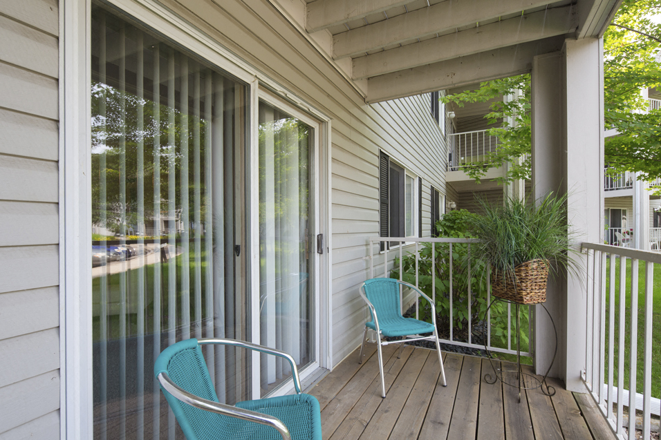 Personal outdoor patio with two blue chairs