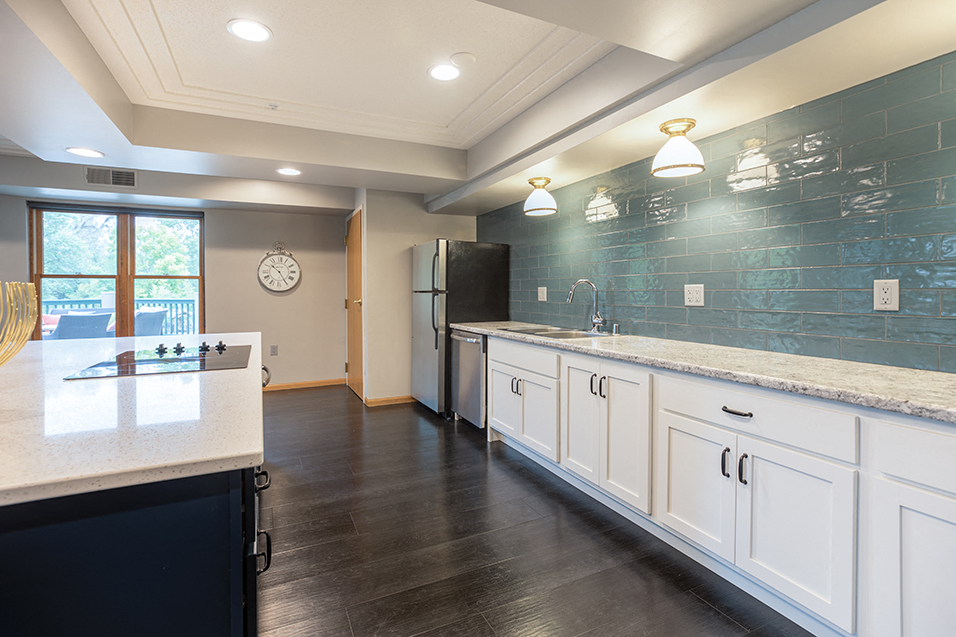 Community kitchen with a stovetop, sink, and refrigerator