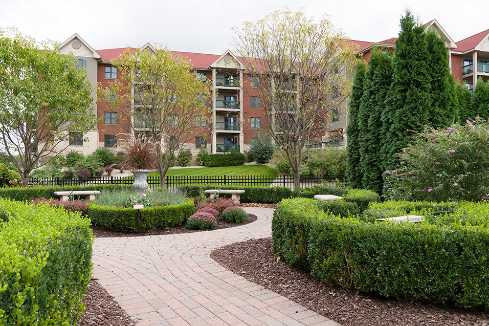 Garden with stone footpaths in front of apartment building
