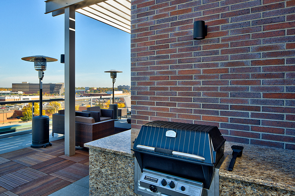 Grill and patio seating on the roof