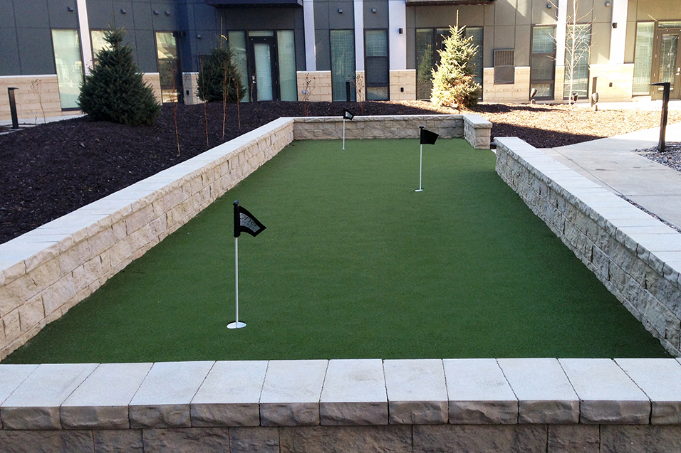 Outdoor putting green with three holes with small flags in them