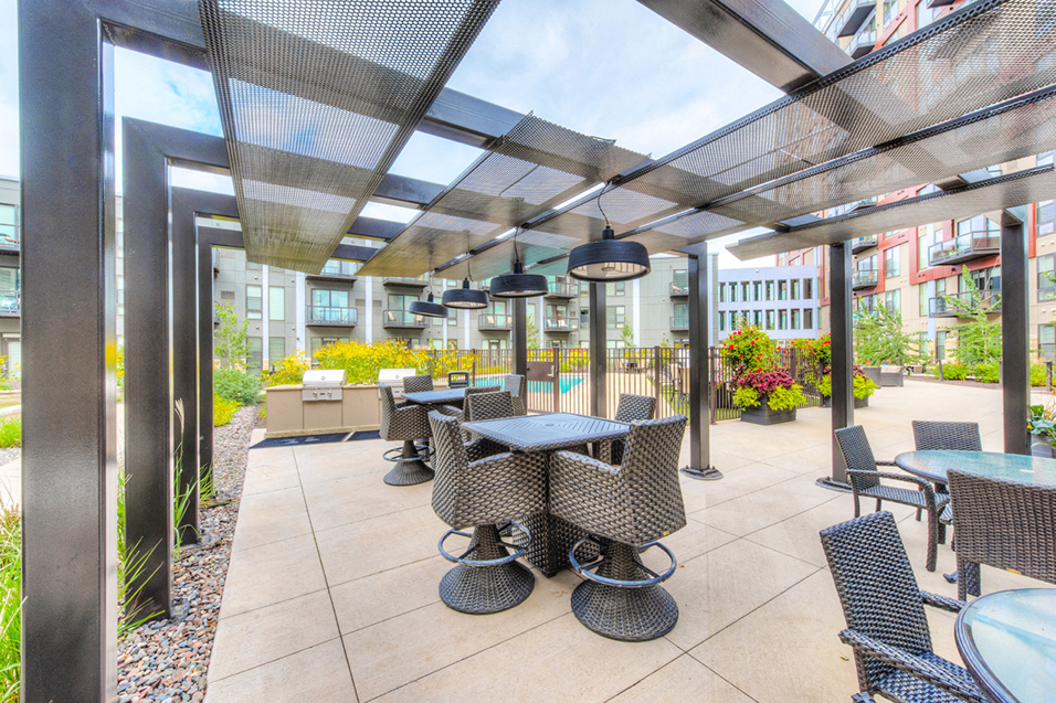 Outdoor seating under a sun terrace with heat lamps hanging above
