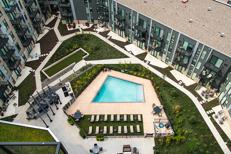Aerial shot of center of the property, with walking paths and a pool in the center