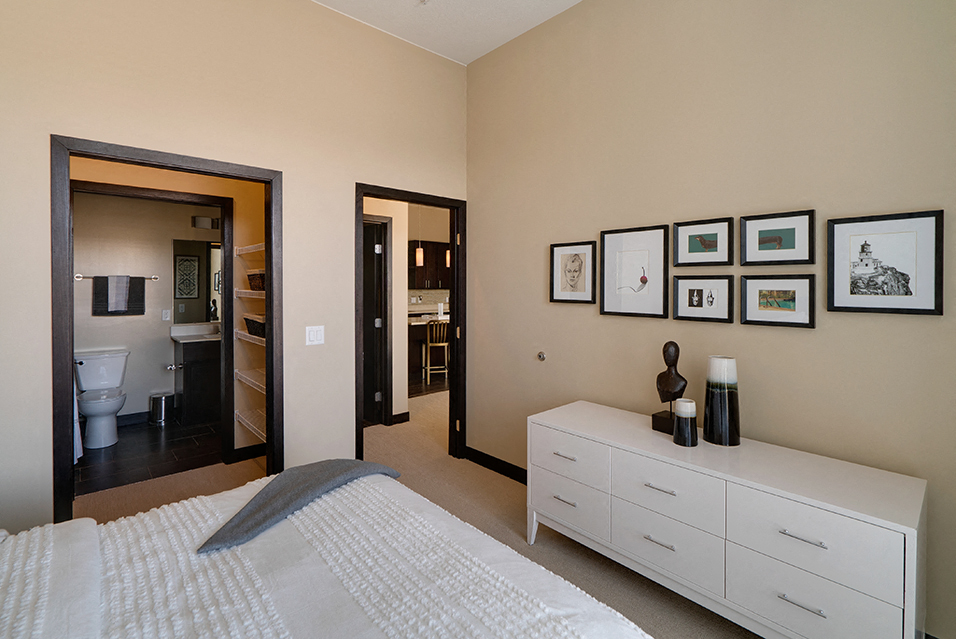 Bedroom with connected walk in closet and bathroom