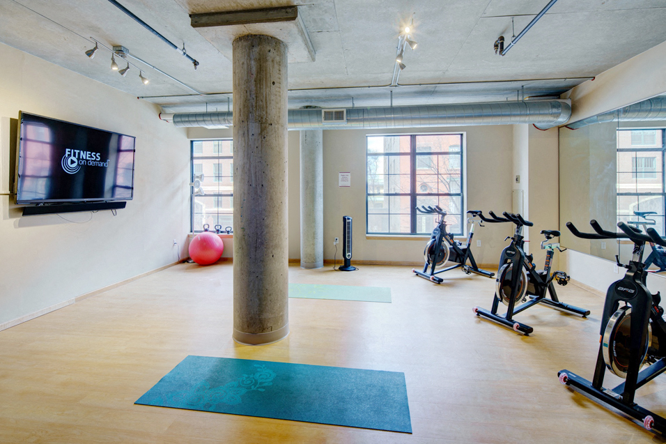 Yoga studio with ellipticals and a TV