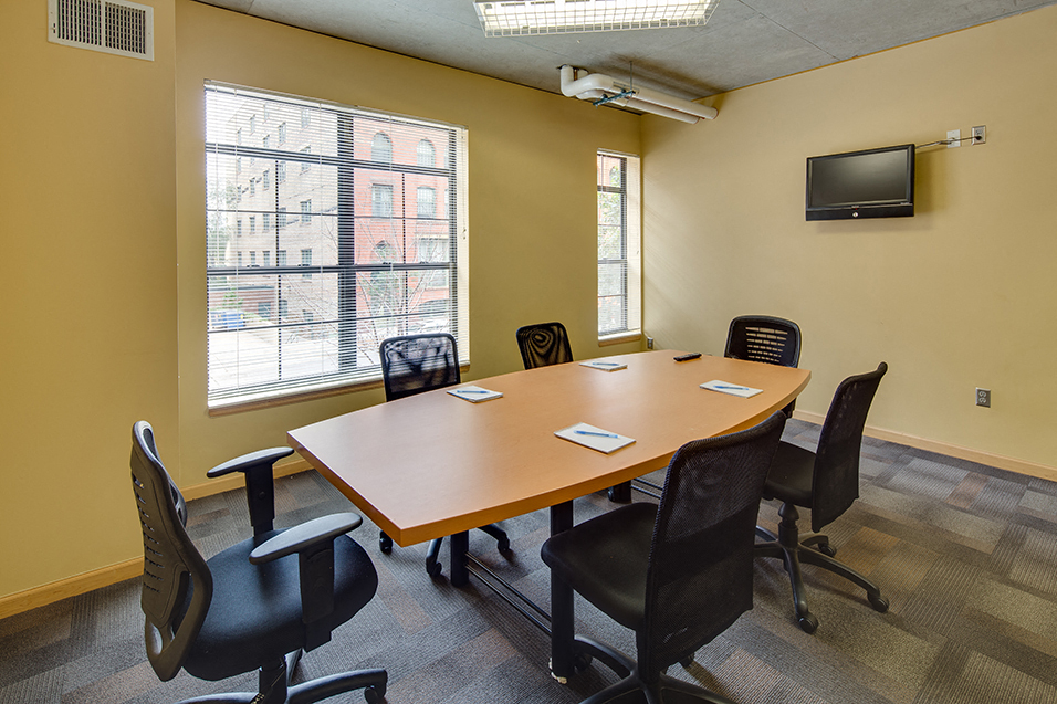 Conference room with oval table and office chairs