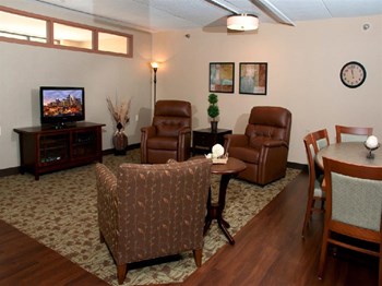 Community room with leather chairs facing a TV - Photo Gallery 7