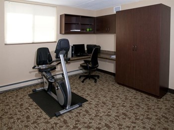 Room with an eliptical and desktop chair and computer - Photo Gallery 5