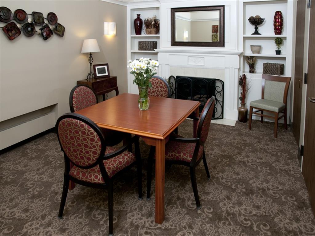 A dining room with a wooden table and chairs.