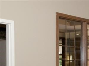 Conference room with wooden table, surrounded by maroon red chairs, and gray sofa chairs in the corner - Photo Gallery 6
