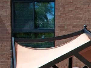 Outdoor patio with rocking bench, circle table, and various shade awnings - Photo Gallery 3