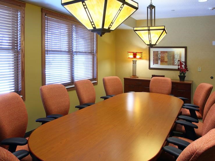 a conference room with a wooden table and chairs