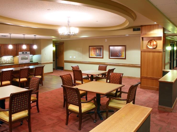 a large dining room with tables and chairs