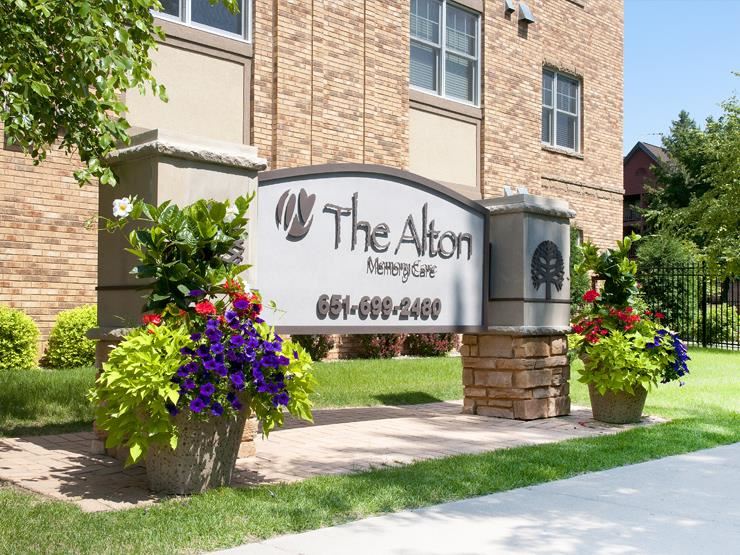 Sign outside of apartment building that reads "The Alton Memory Care"