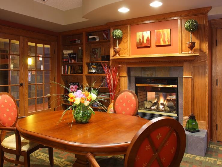 a dining room with a table and chairs and a fireplace