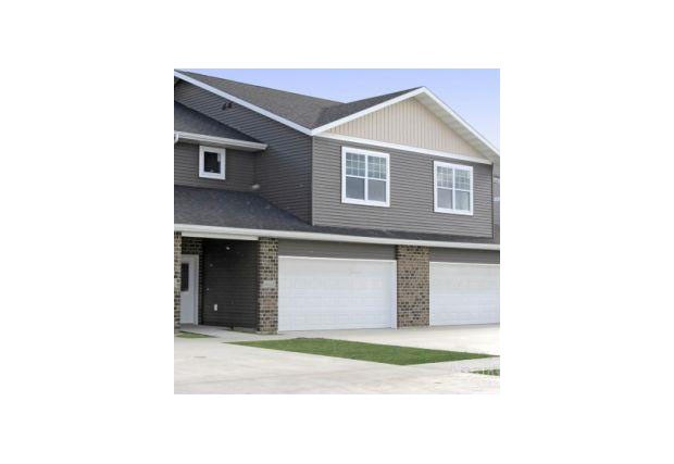 a house with two garage doors and a driveway