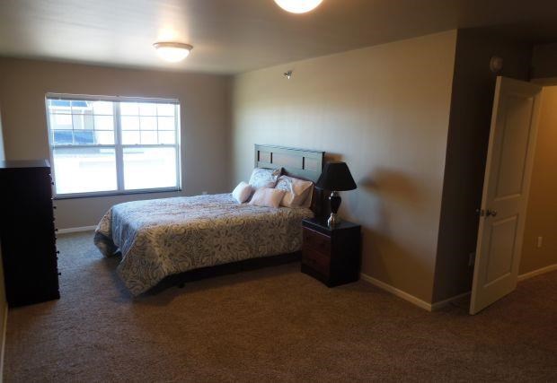 a bedroom with a bed and a window