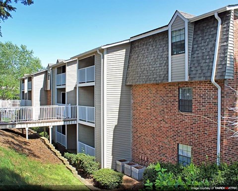 an image of a brick apartment building with balconies