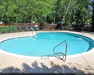 a large swimming pool with a fence around it