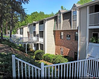 an apartment building with a white fence