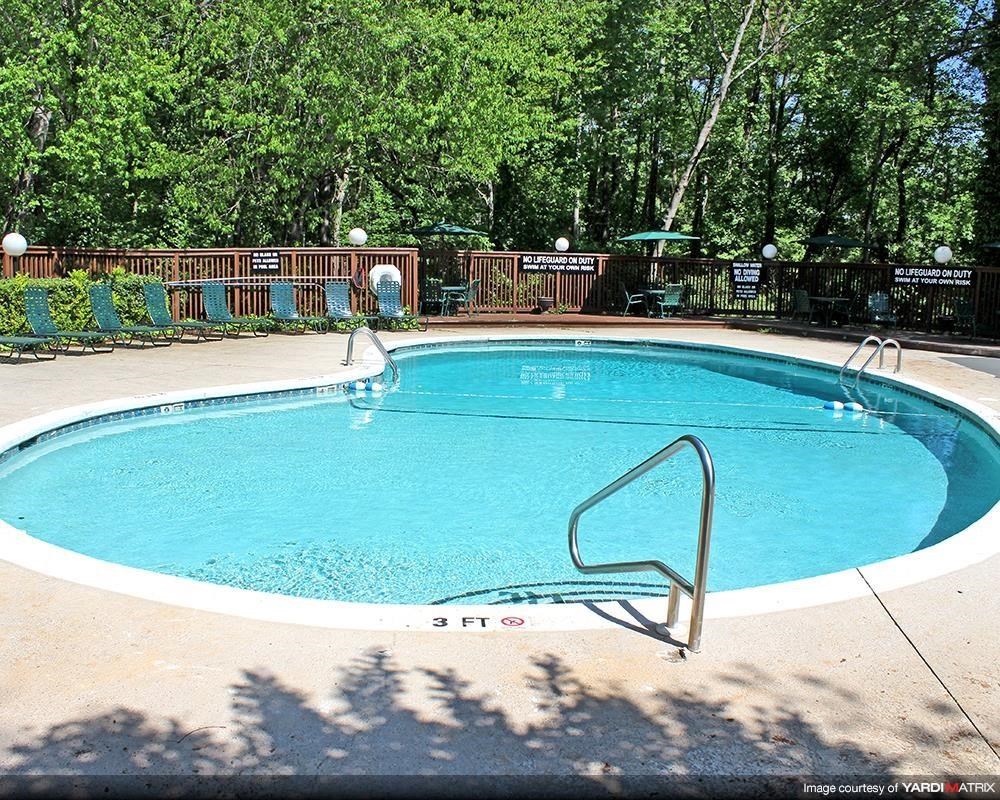 a large swimming pool with a fence around it