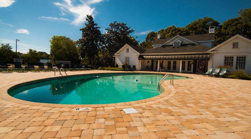 a swimming pool with a house in the background