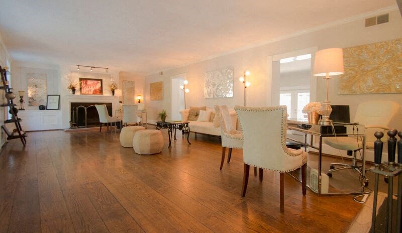 a living room with white furniture and a table